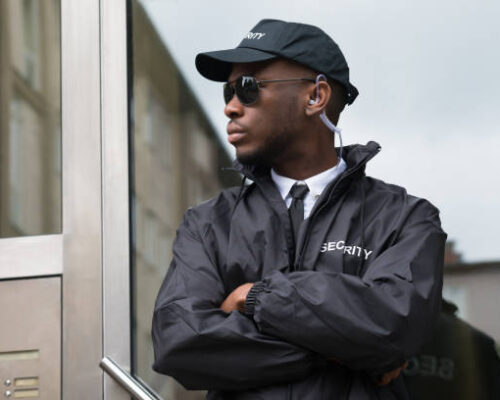 Portrait Of Young African Male Security Guard Standing Arms Crossed Portrait Of Young African Male Security Guard Standing Arms Crossed